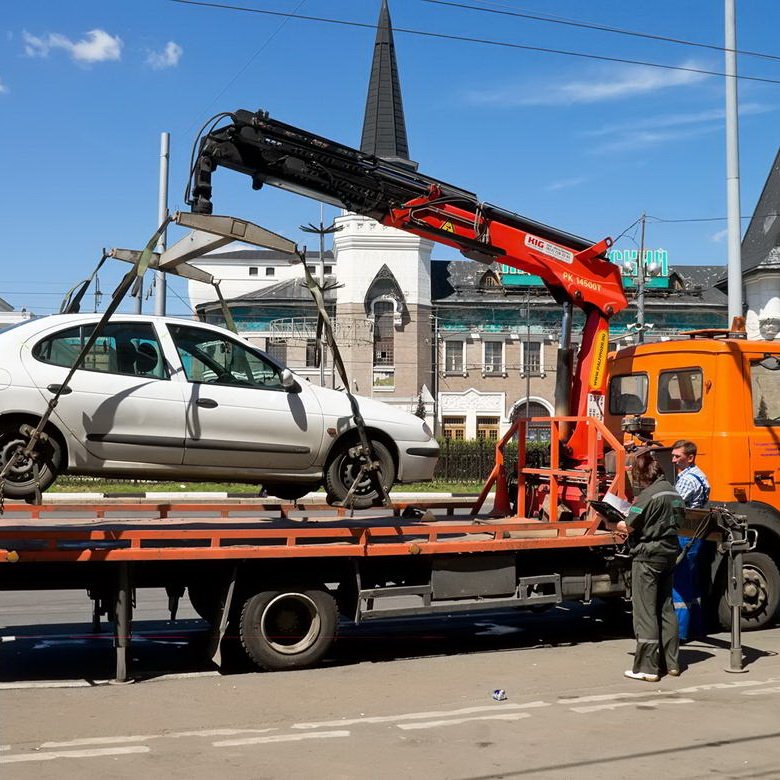 Flatbed Towing a White Car